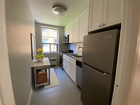a kitchen with stainless steel appliances and white cabinets