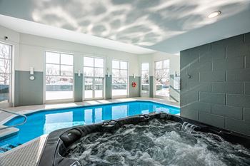 Indoor pool and whirlpool at Bourg du Village in Ste Therese Quebec