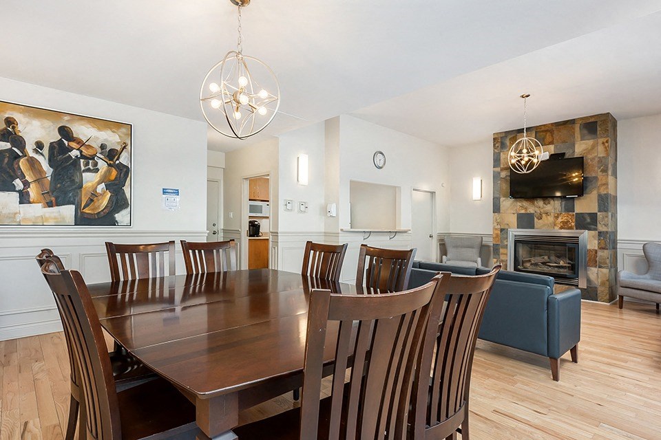 Bourg Du Village social room showing dining area in Sainte Therese, QC