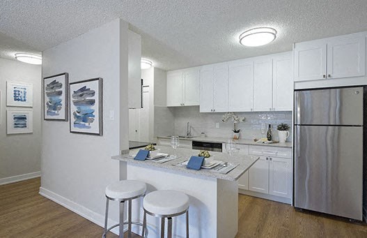 Braemar Gardens apartments kitchen featuring stainless steel appliances and breakfast seating in Coquitlam, BC