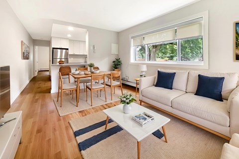 A living room with a white couch and a coffee table.