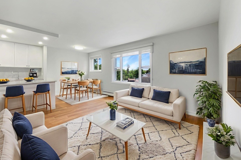 A living room with a couch, chairs, and a coffee table.