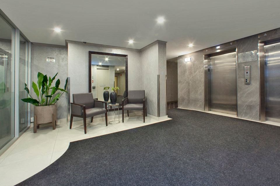 Brookbanks Apartments in Toronto, ON lobby and elevator area with lounge chairs
