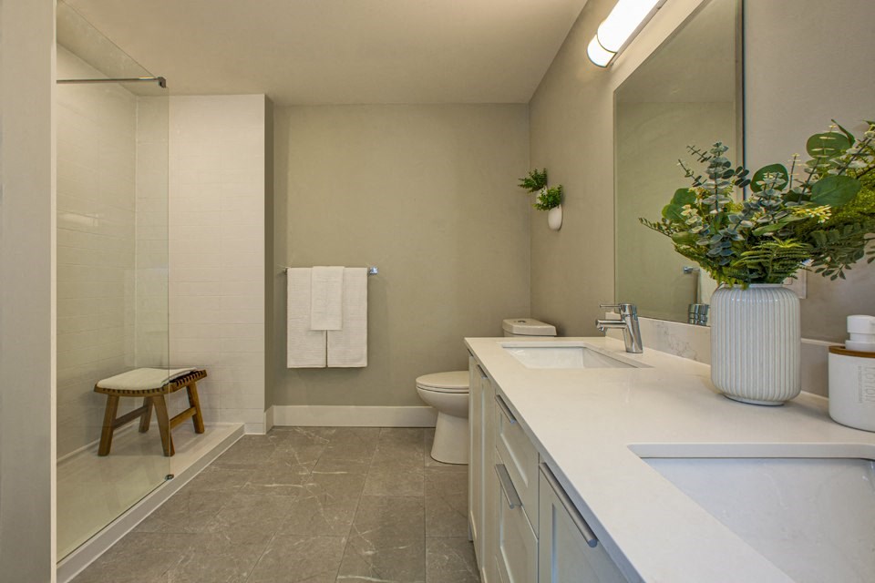 a bathroom with a toilet sink and shower