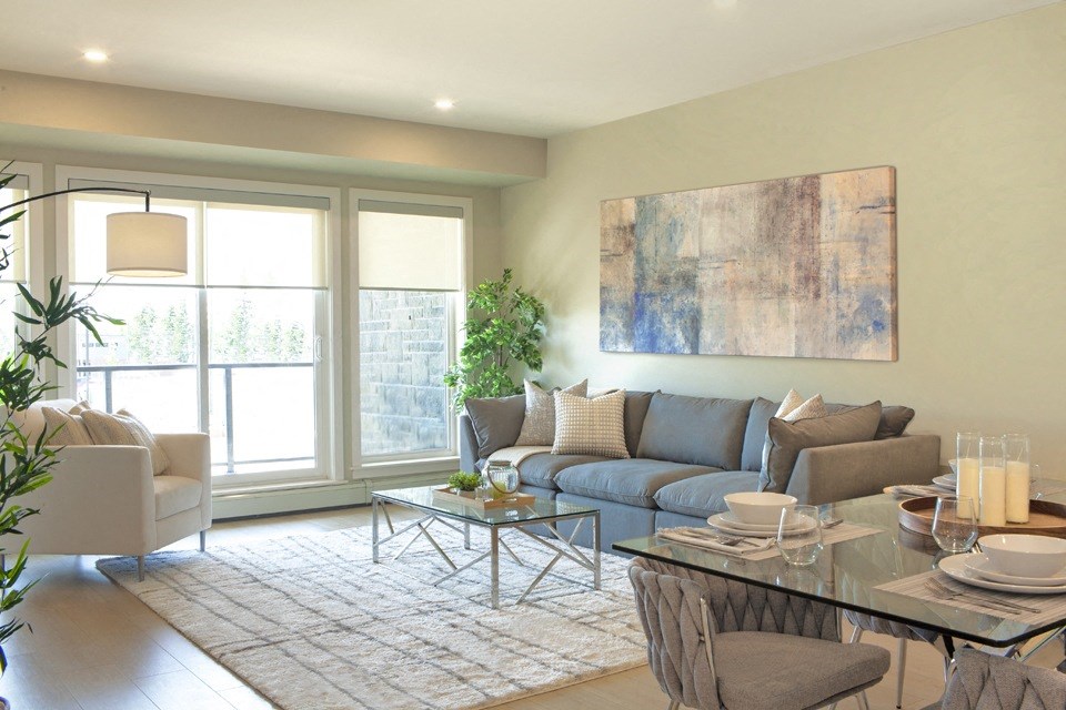 a living room with a blue couch and a glass coffee table