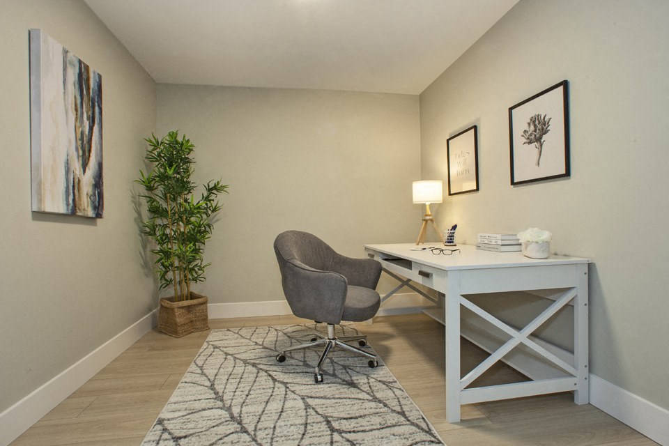 a home office with a desk and chair