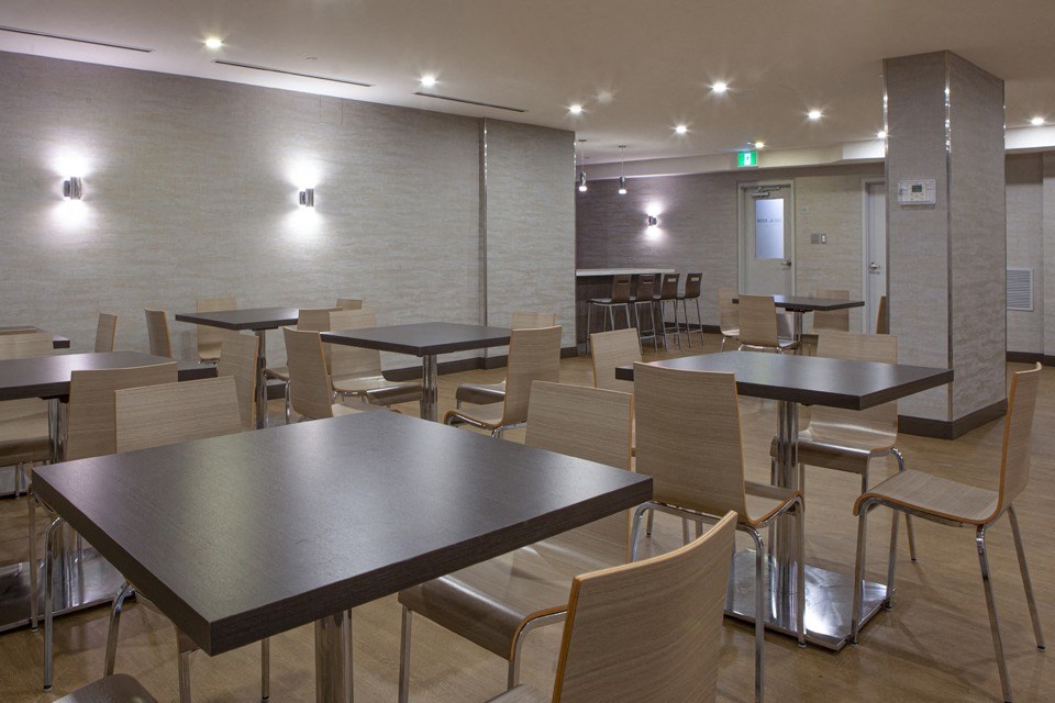 A conference room with a long table and chairs.
