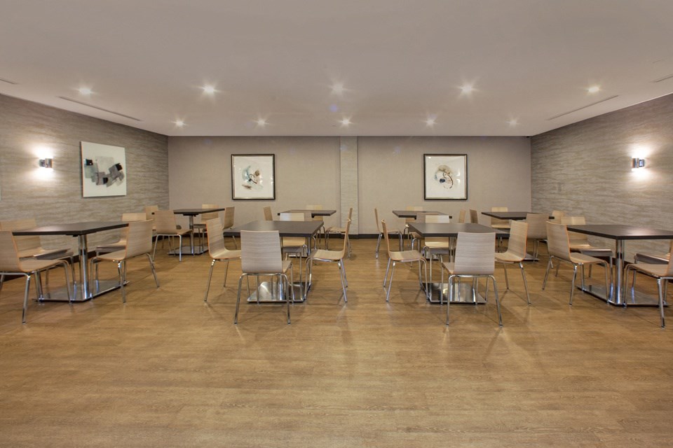 A room with tables and chairs and pictures on the wall.