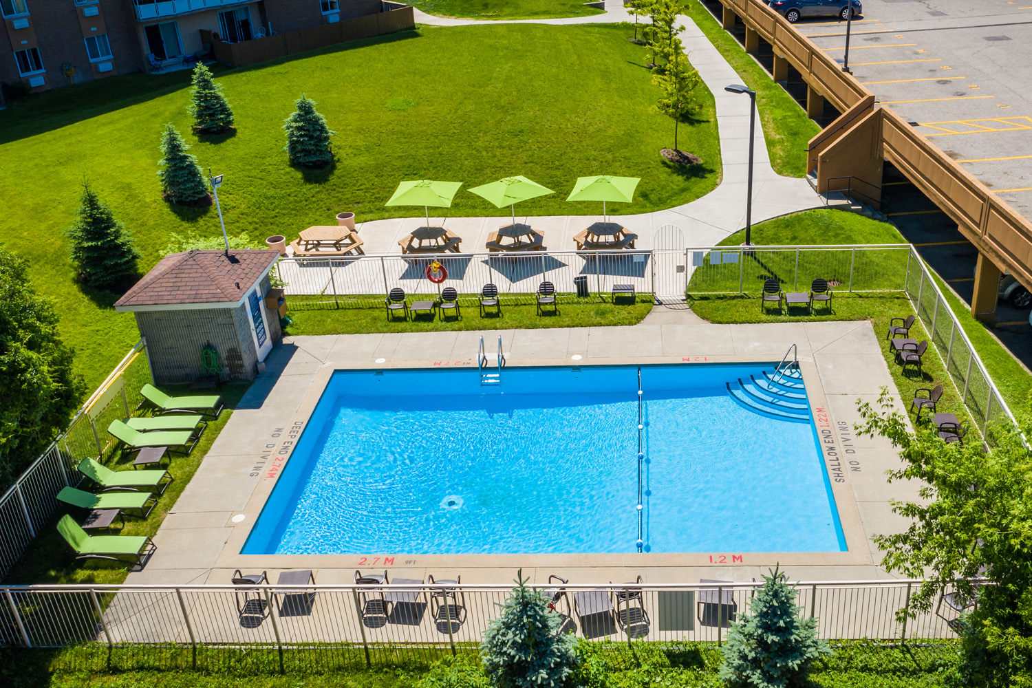 Capitol Hill in Kitchener, ON outdoor pool with tanning chairs and picnic tables