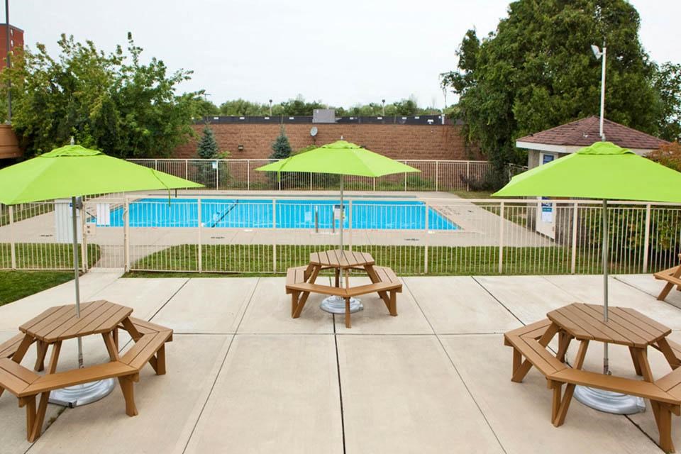 Capitol Hill in Kitchener, ON outdoor pool with picnic tables and umbrellas