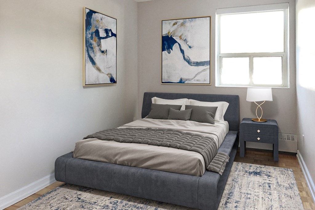 a bedroom with a bed and two paintings on the wall