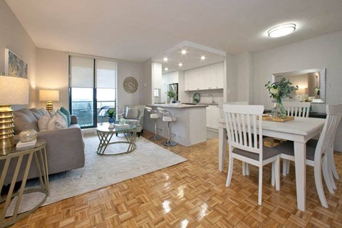 a living room and kitchen with a table and chairs