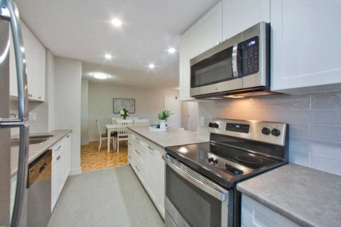 a kitchen with stainless steel appliances and a microwave
