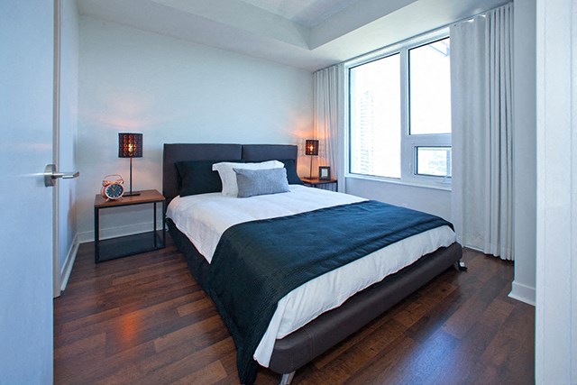 Cityview Apartments Bedroom with black blanket over foot of the bed in Brampton, ON