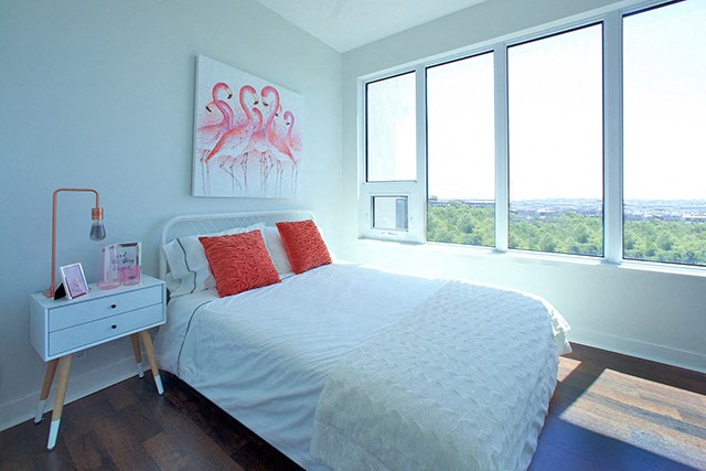 Cityview Apartments Bedroom with orange pillows and white sheets in Brampton, ON