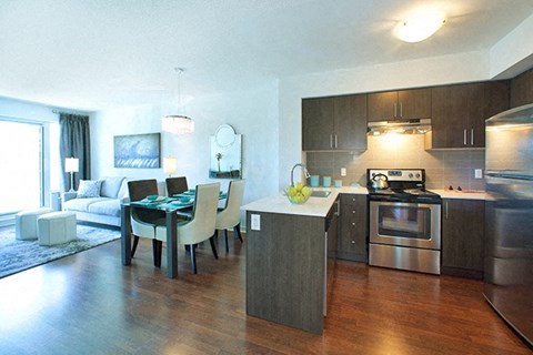 A modern kitchen with a dining table and chairs.