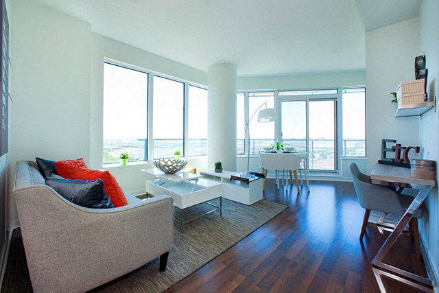 Cityview Apartments Open living room with orange pillows and a balcony in Brampton, ON