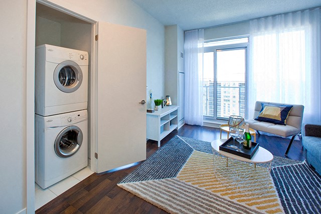 Cityview Apartments In suite laundry room next to the living room with a stripped rug in Brampton, ON
