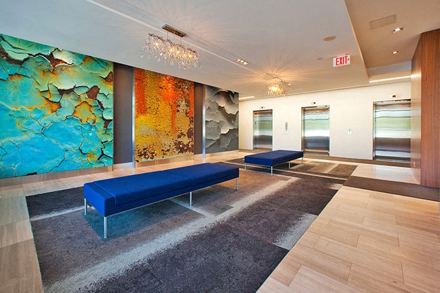 Cityview Apartments Lobby with blue benches and three elevators in Brampton, ON