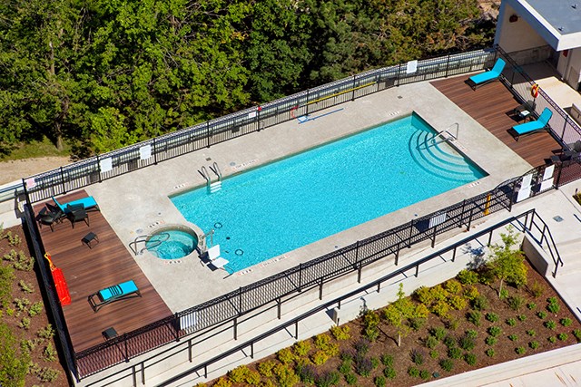 Cityview Apartments Crystal clear pool with four light blue chairs in Brampton, ON