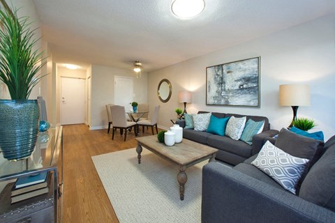 A living room with a grey couch and a wooden coffee table.