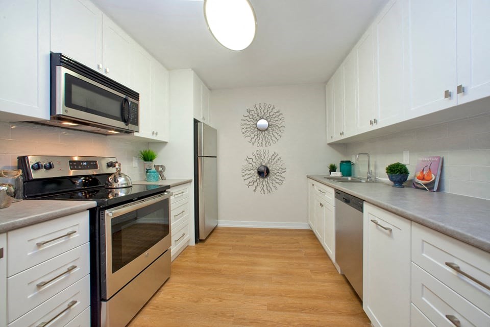 Dorchester Apartments contemporary kitchen with white cabinetry and stainless steel appliances in Niagara Falls, ON