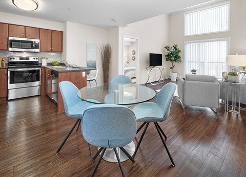 A modern kitchen with a dining table and chairs.