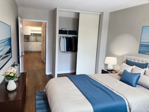 A bedroom with a large bed and a view of the ocean through a window  at Angus House in Toronto  at Angus House in Toronto