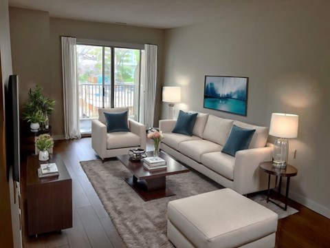 A living room with a white couch, a coffee table, and a painting on the wall.