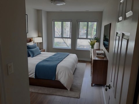 A bedroom with a bed, nightstand, and a window at Angus House in Toronto