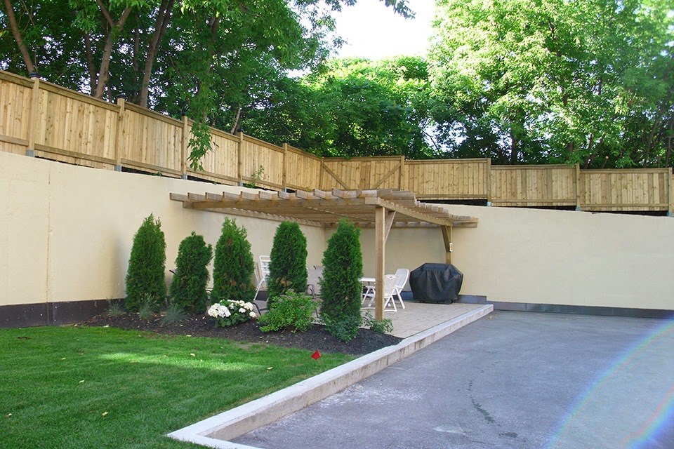 Backyard with BBQ and tables and chairs at Bradford Place Apartments in Bradford, ON