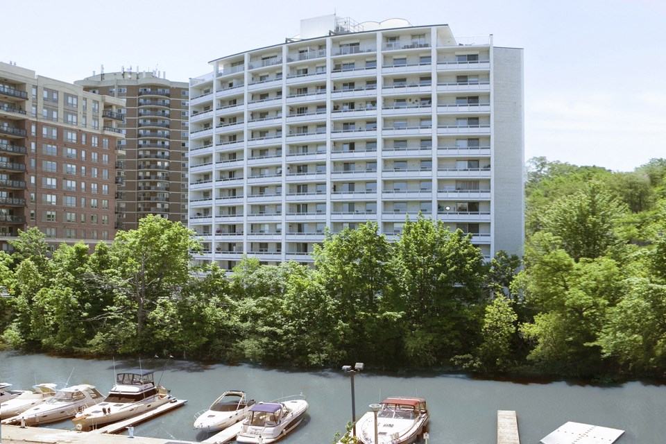 Harbourview Apartments building exterior featuring view of nearby marina in Oakville, ON