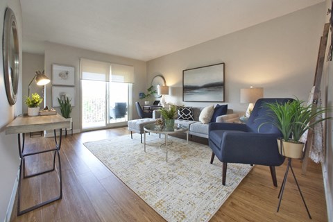 a living room with a blue couch and a white rug