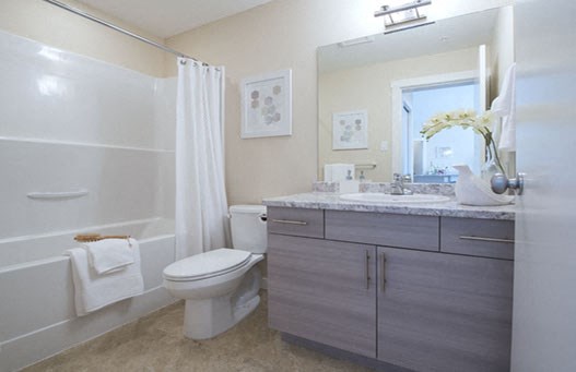 Hoylake Apartments in Victoria, BC bathroom with full sized bathtub and large mirror