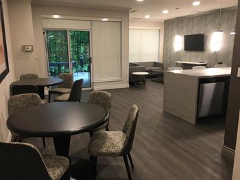 social room with tables, chairs, couch and kitchen at 17 Brookbanks in Toronto ON
