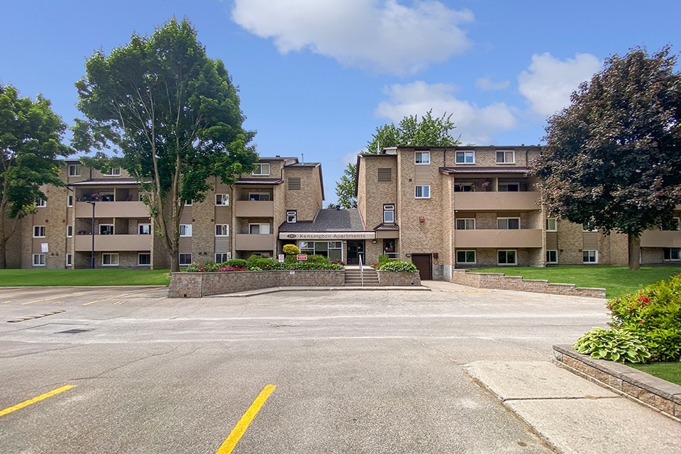 Front of Kensington Apartments in Brockville Ontario showing the main building entrance from the parking lot