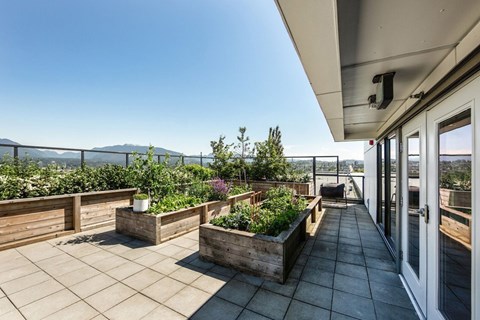 A patio with a view of the mountains and a fence at 388 Kaslo East Village.