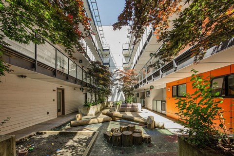A view of a courtyard with a fountain and trees at 388 Kaslo East Village.