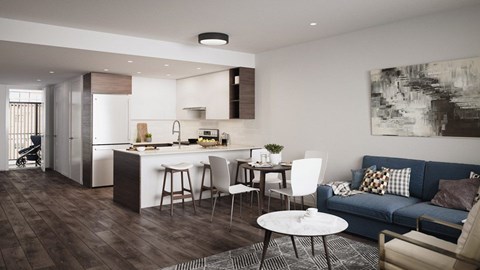A modern kitchen with a dining table and chairs is adjacent to a living room with a couch and a coffee table.
