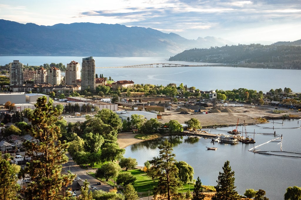 the city with a lake and mountains in the background