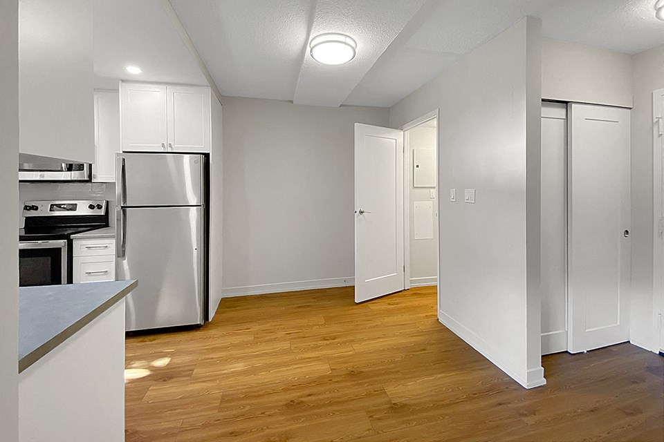 Kensington Apartments in Brockville showing dining room with storage room off side wall, kitchen on left and entry on right