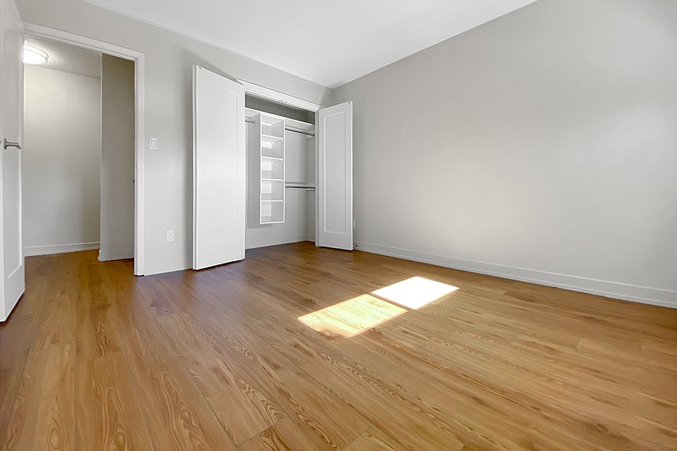 Kensington Apartments primary bedroom from corner of room looking towards closet with built in storage
