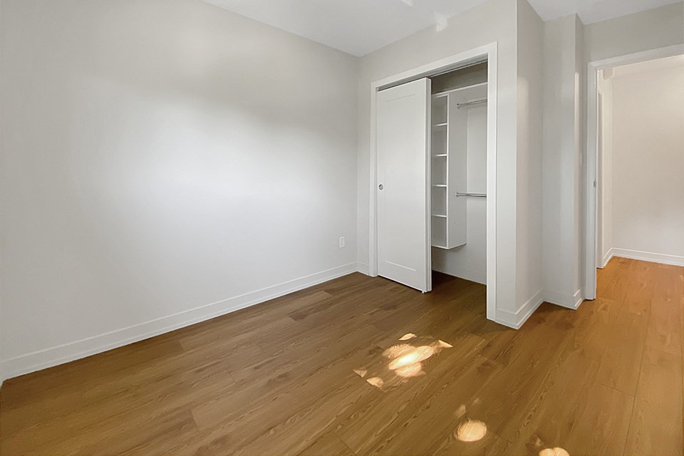 Kensington Apartments second bedroom looking towards closet with sliding doors and built-in closet storage