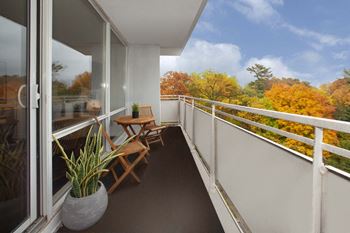 a balcony with a table and chairs on it