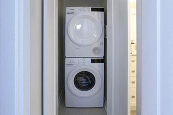 a washing machine and dryer in a small room
