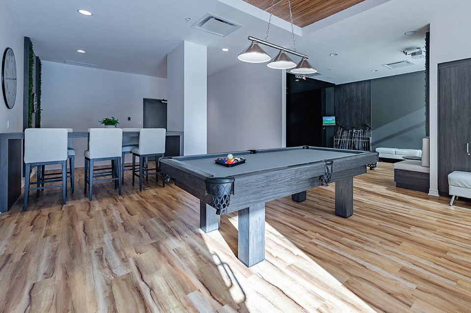Games room featuring billiards table and additional seating at La Voile Pointe-Claire apartments in Pointe-Claire, Quebec