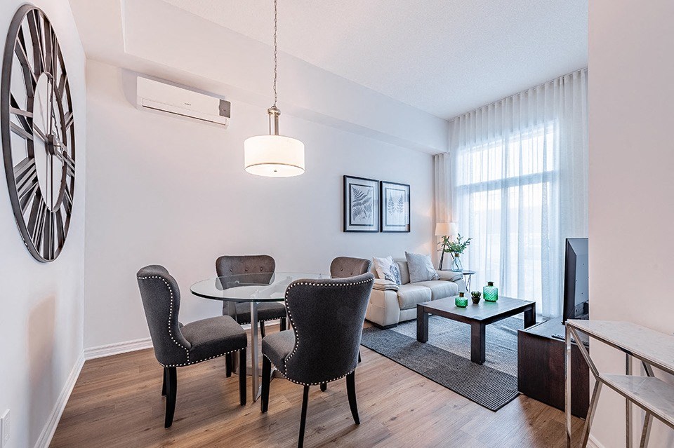 Dining room with luxury vinyl flooring and modern furnishing at La Voile Pointe-Claire apartments in Pointe-Clare, Quebec