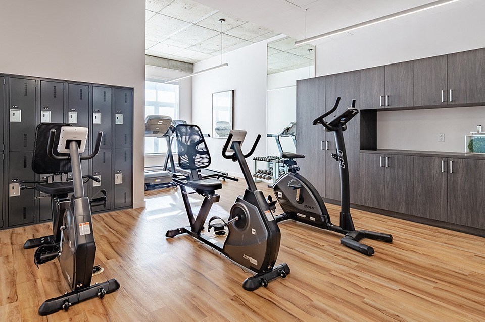 Fully equipped fitness centre and yoga studio at La Voile Pointe-Claire apartments in Pointe-Claire, Quebec