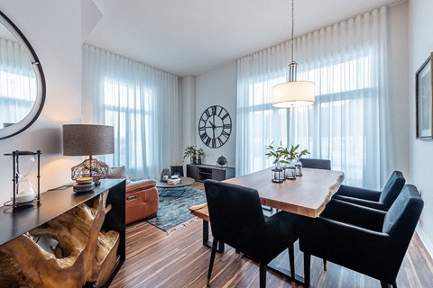 Brightly lit dining room with modern furnishings at La Voile Pointe-Claire apartments in Pointe-Claire, Quebec