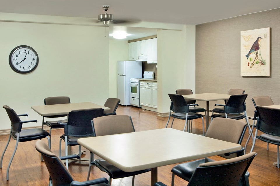 Laura Secord Apartments social room leading into social room kitchen in Niagara Falls, ON